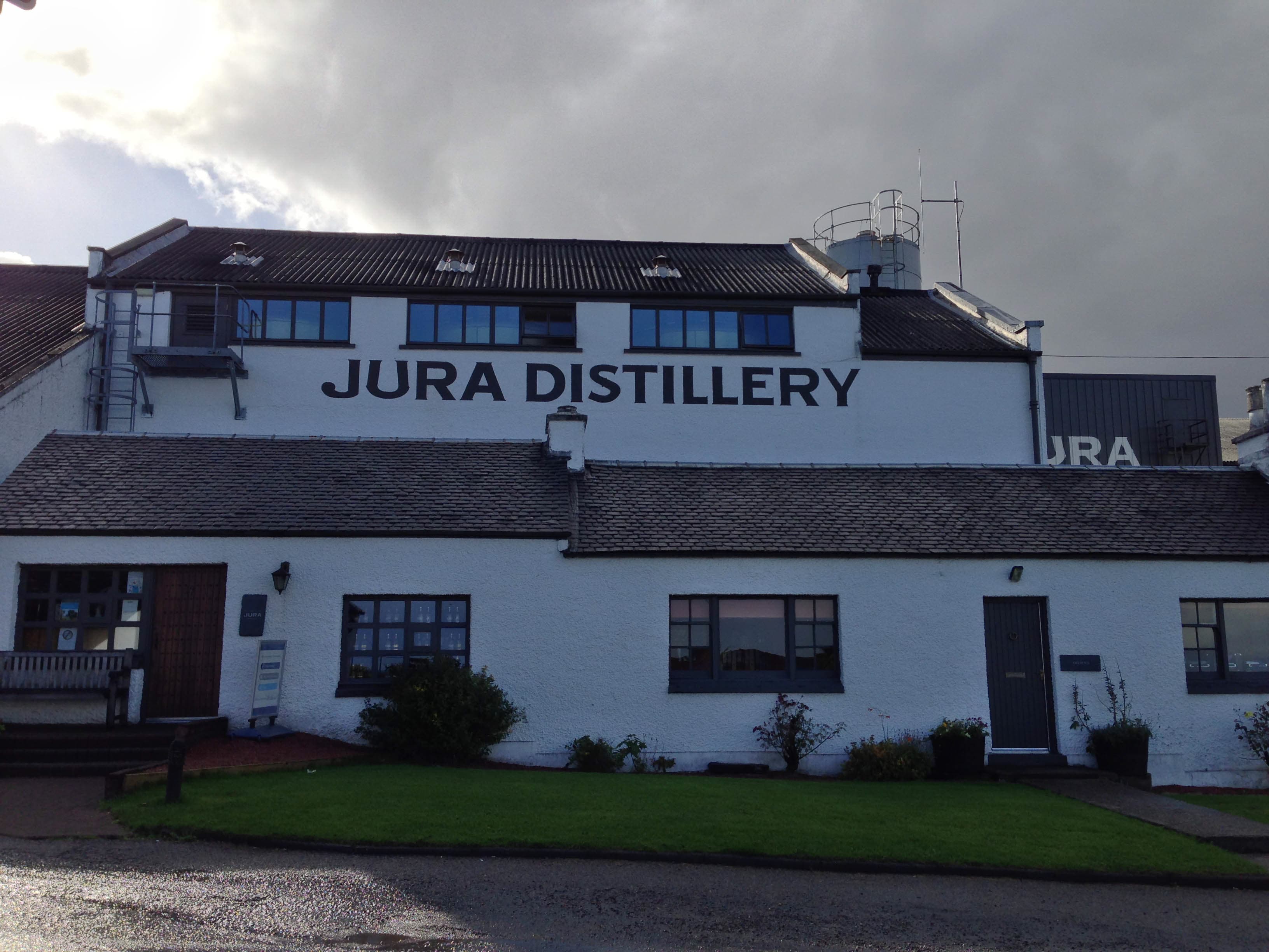 The Jura distillery's white frontage and lettering at Craighouse