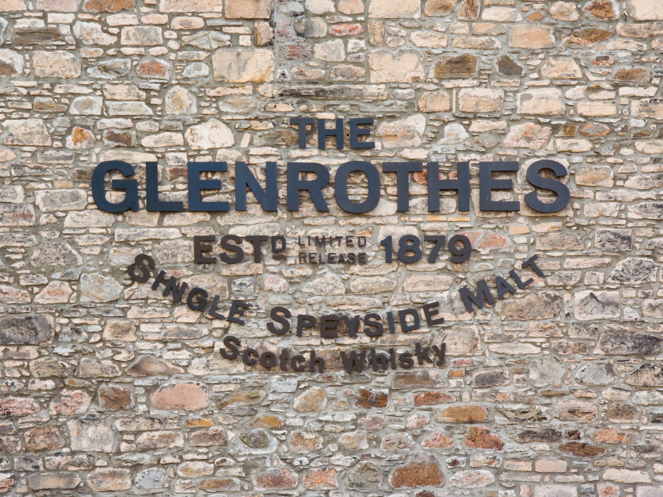 The Glenrothes name carved into the distillery's stone boundary wall at Rothes