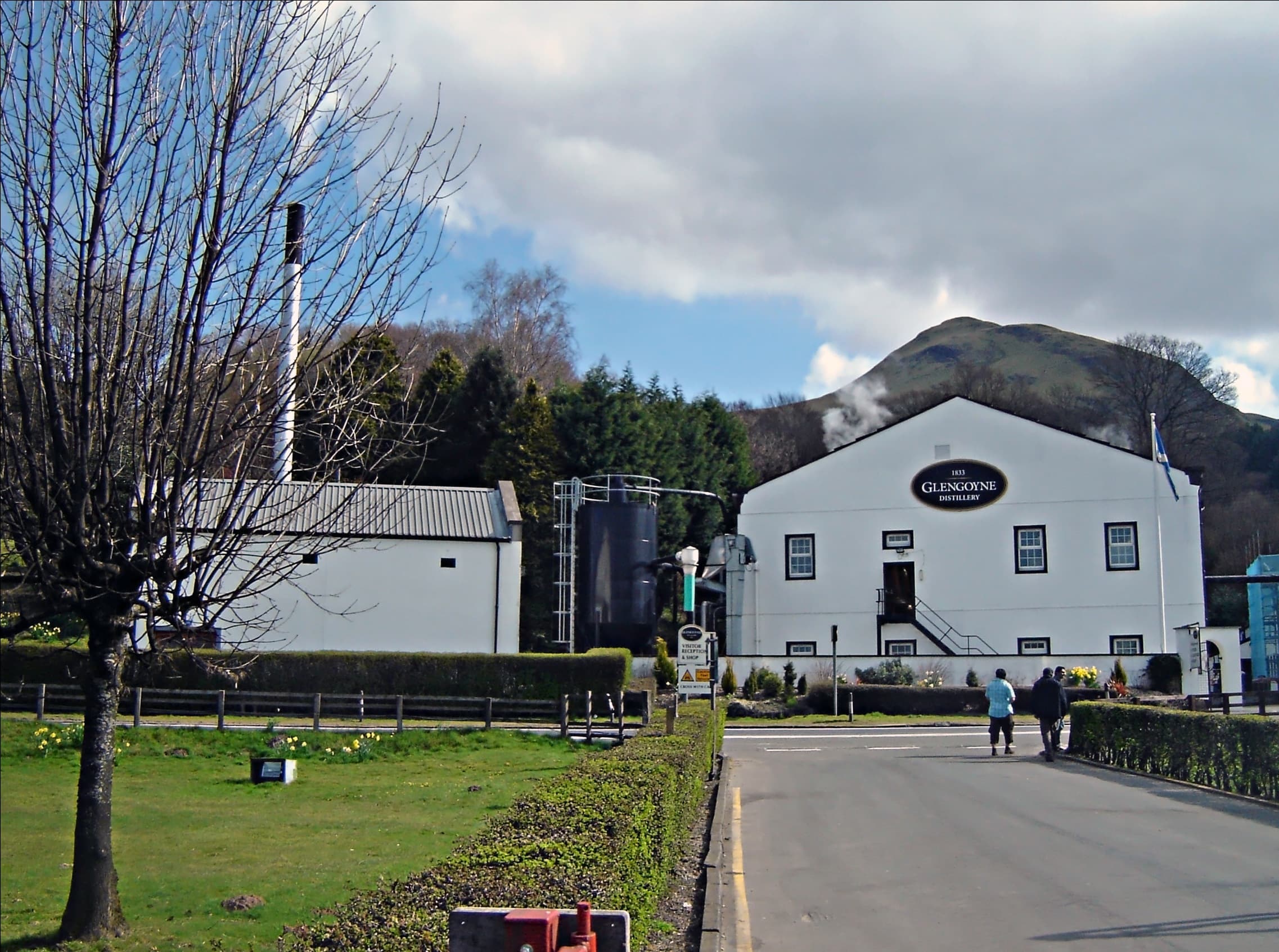 Glengoyne distillery's white buildings at the foot of Dumgoyne
