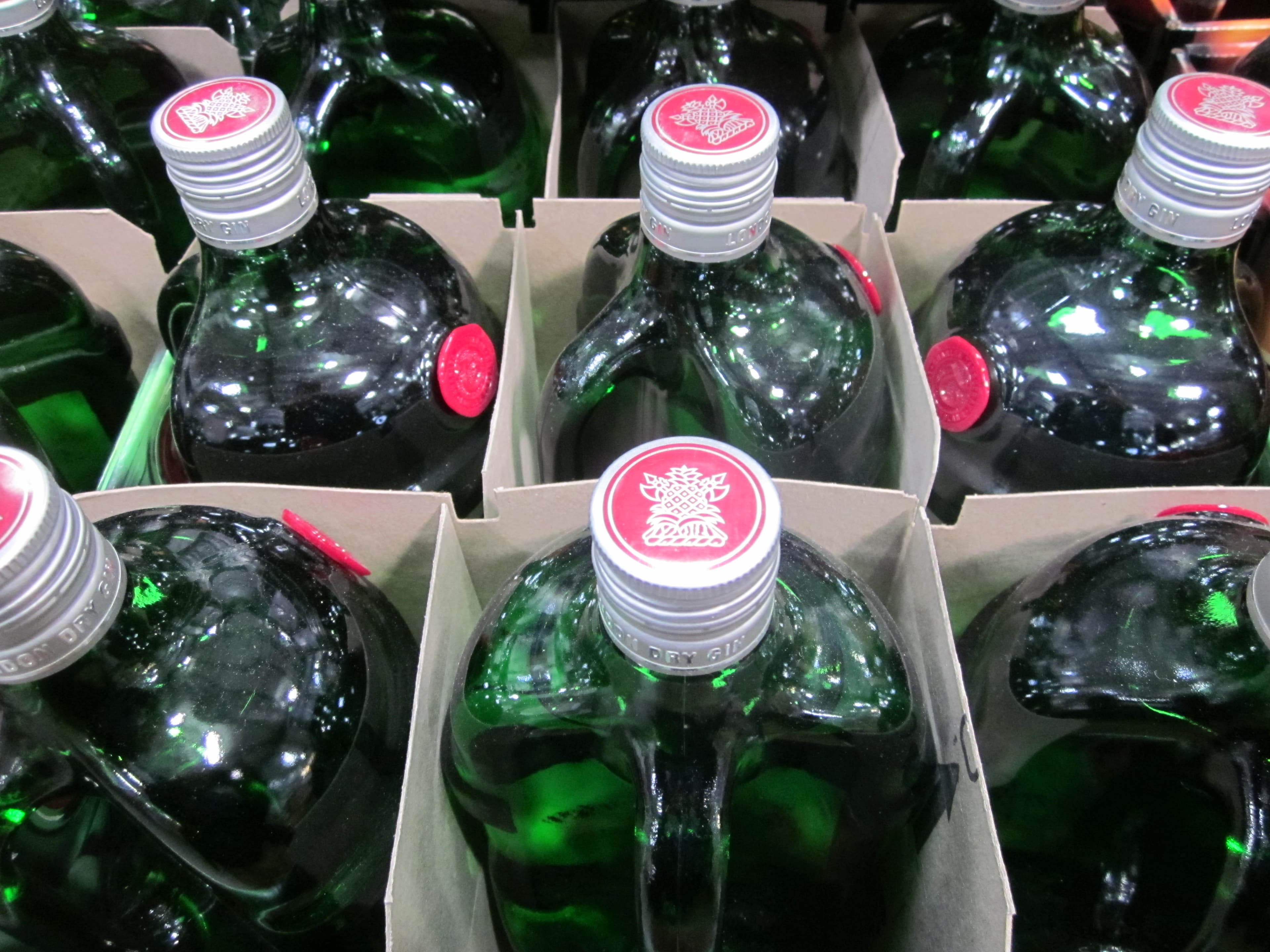 Green Tanqueray London Dry Gin bottles with red seals, packed in cardboard cases