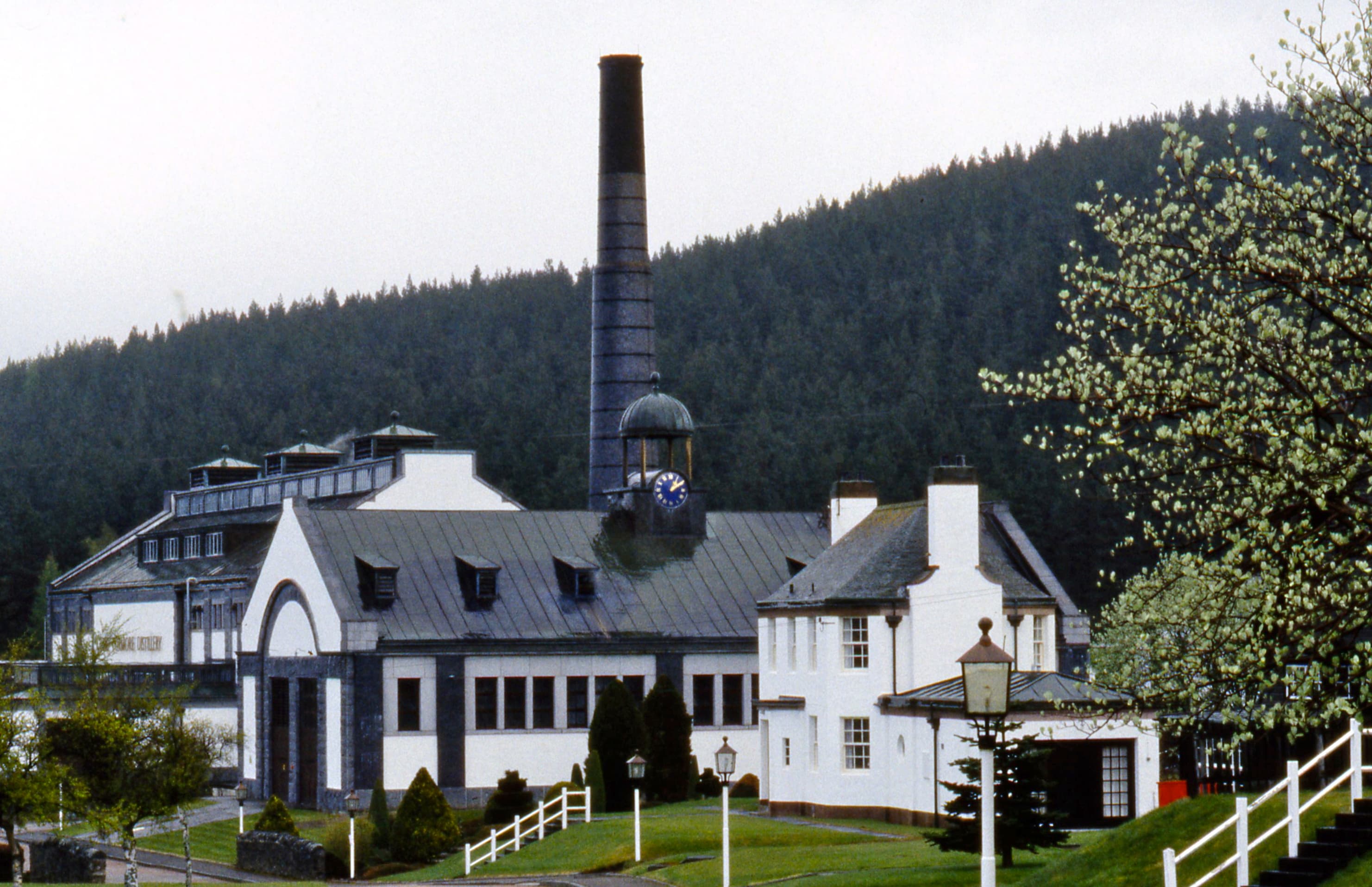 The ornate white frontage and chimney of Tormore distillery