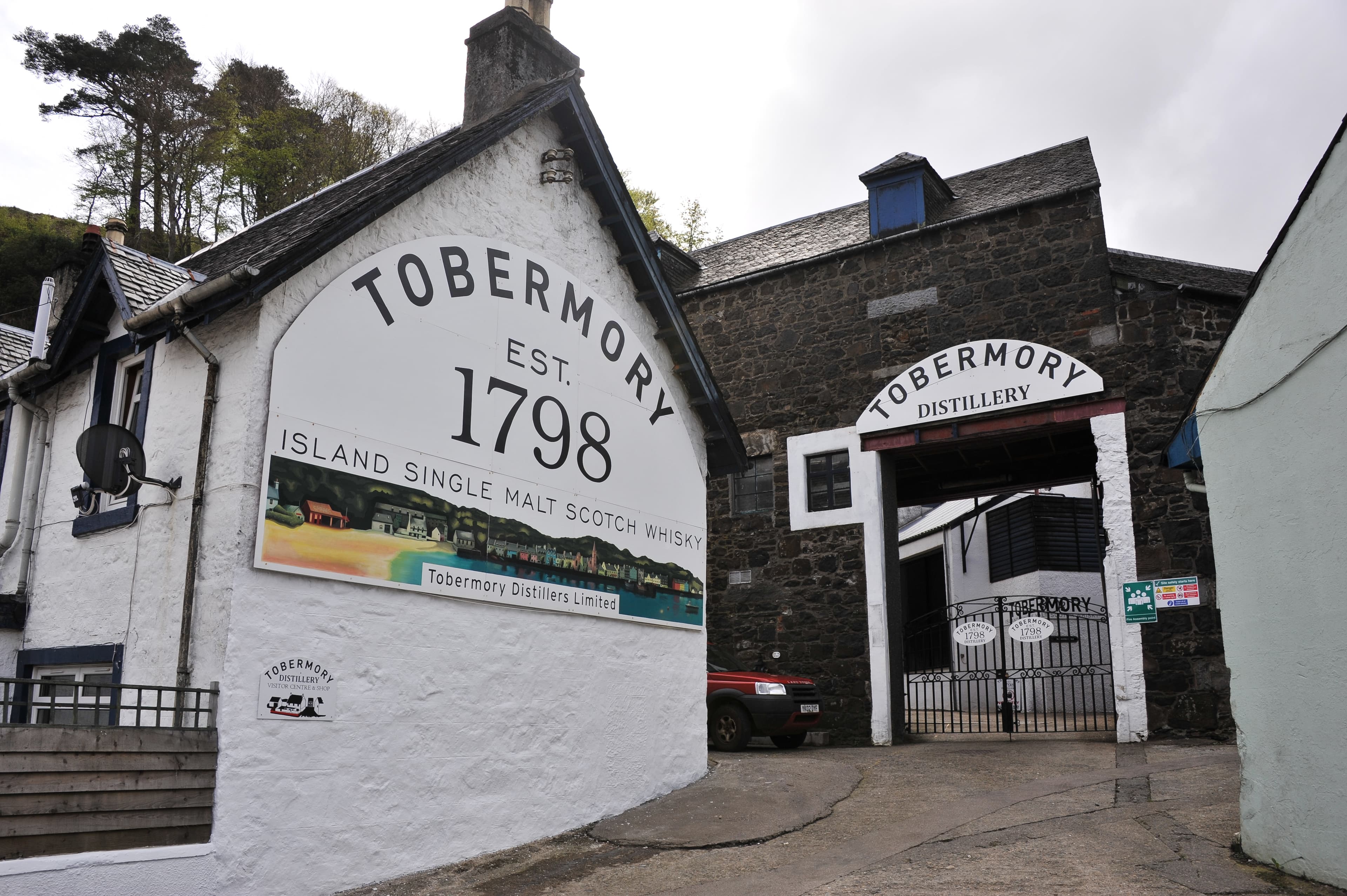 The painted Tobermory distillery wall on the harbour front on Mull
