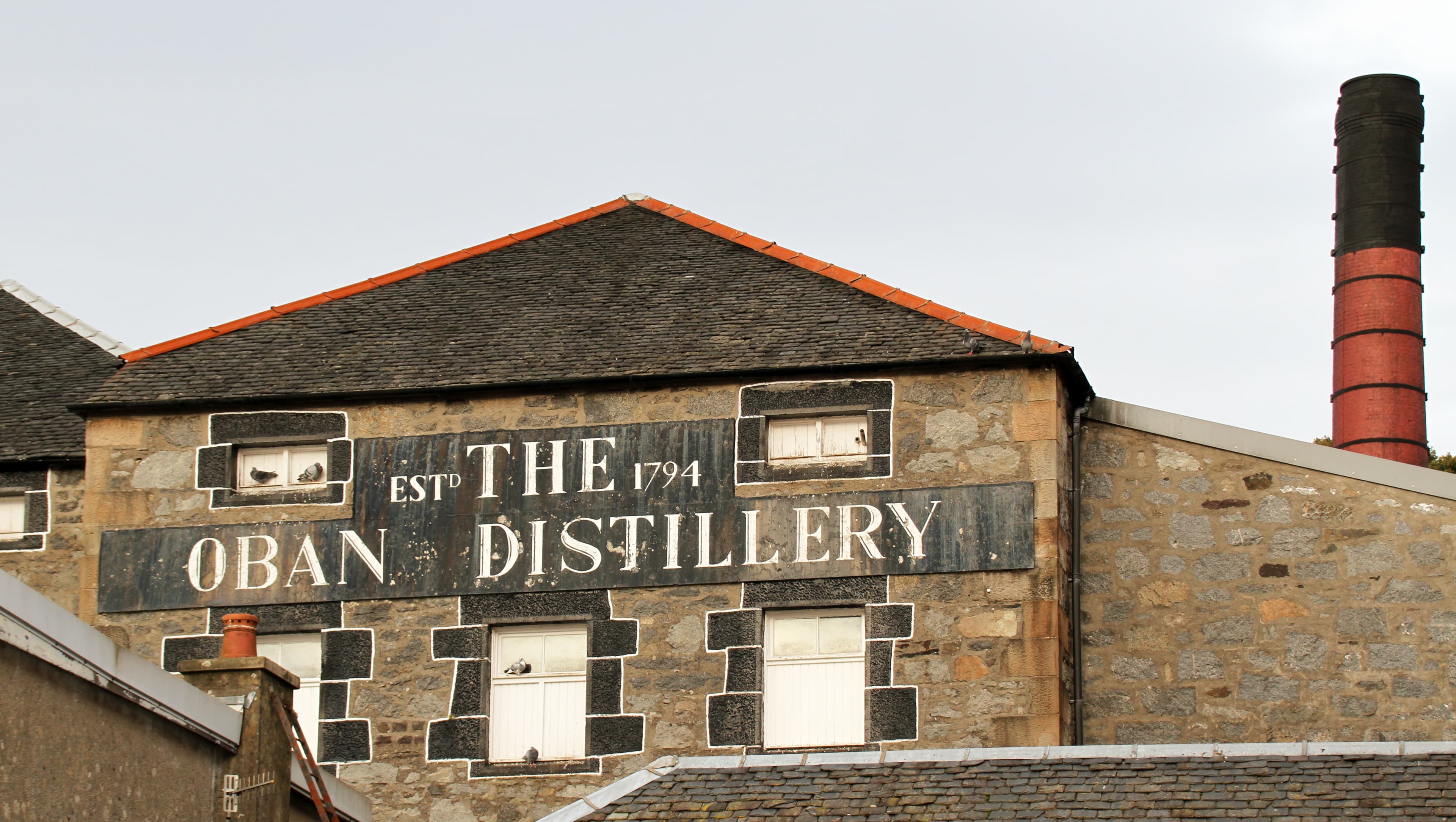 The Oban Distillery's painted gable in the centre of Oban