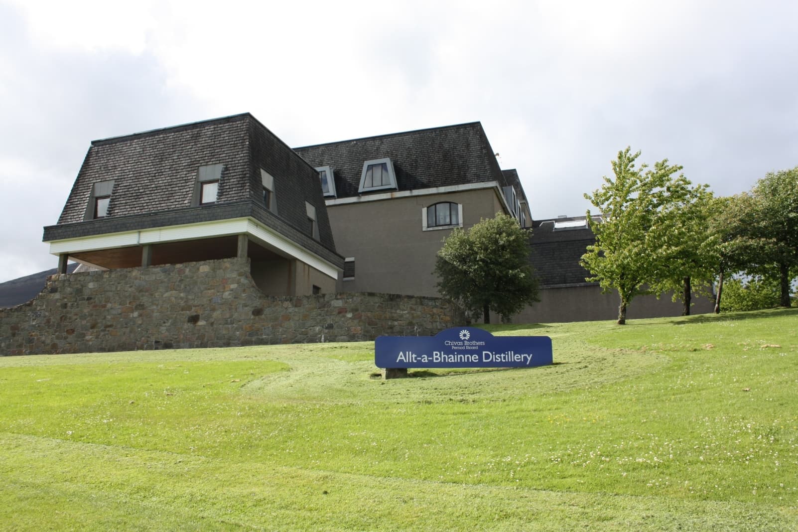 Allt-a-Bhainne distillery and its nameboard in Glen Rinnes