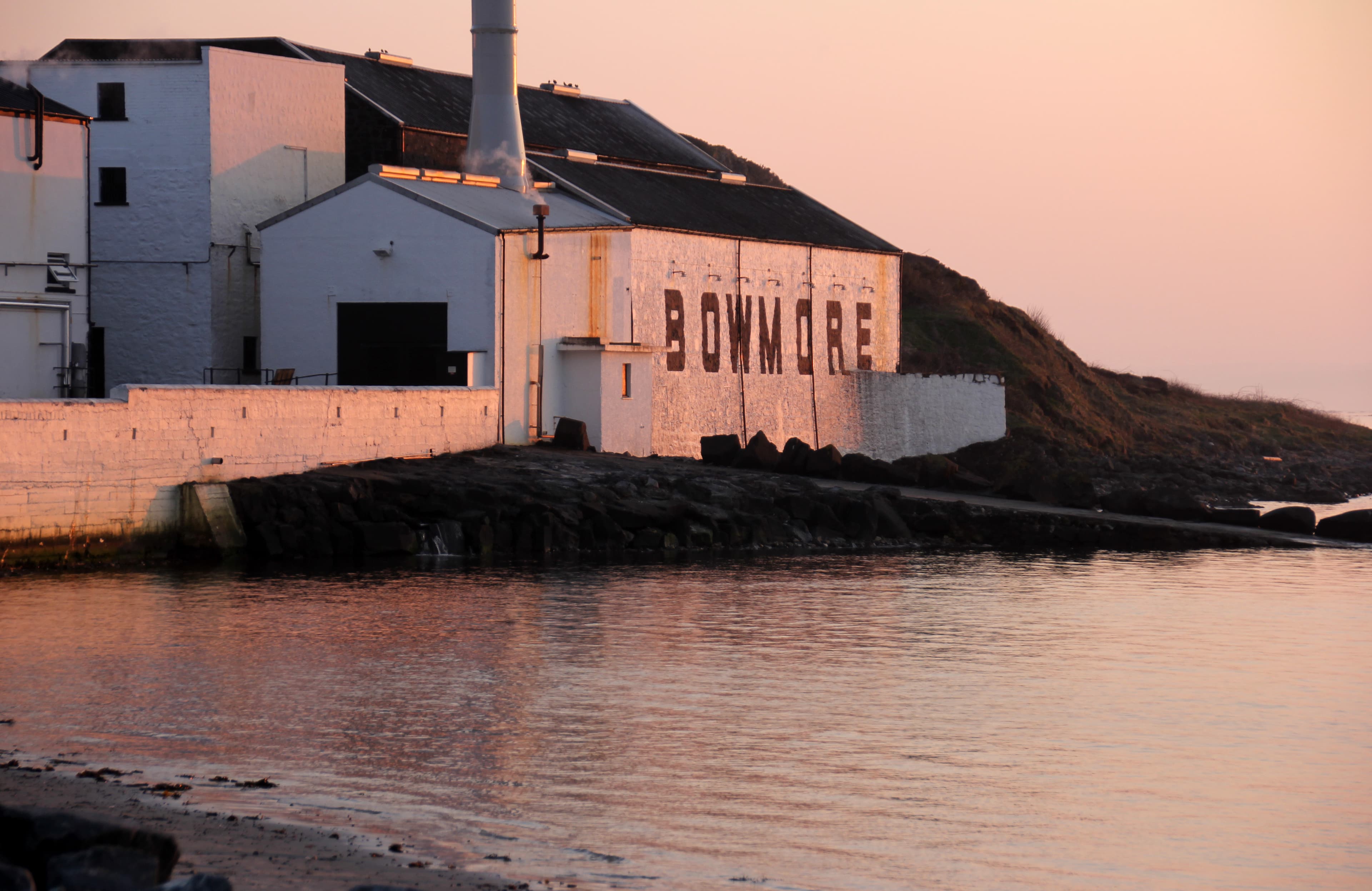 Bowmore distillery's warehouse on Loch Indaal at dusk