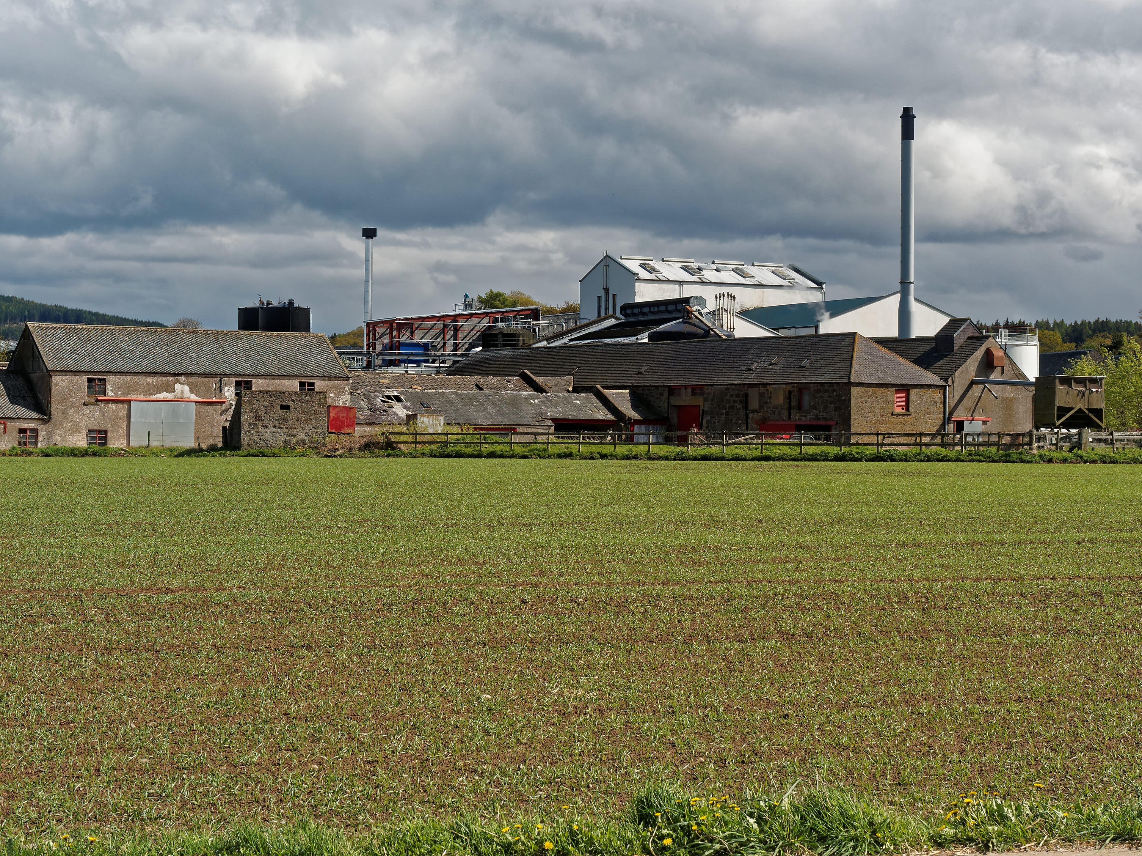 Royal Brackla distillery seen across the fields near Cawdor