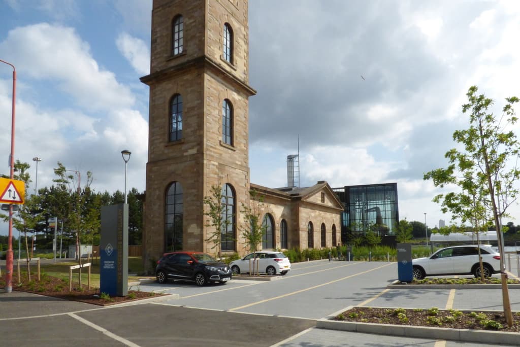 The Clydeside Distillery's pumphouse clock tower and glass still house in Glasgow