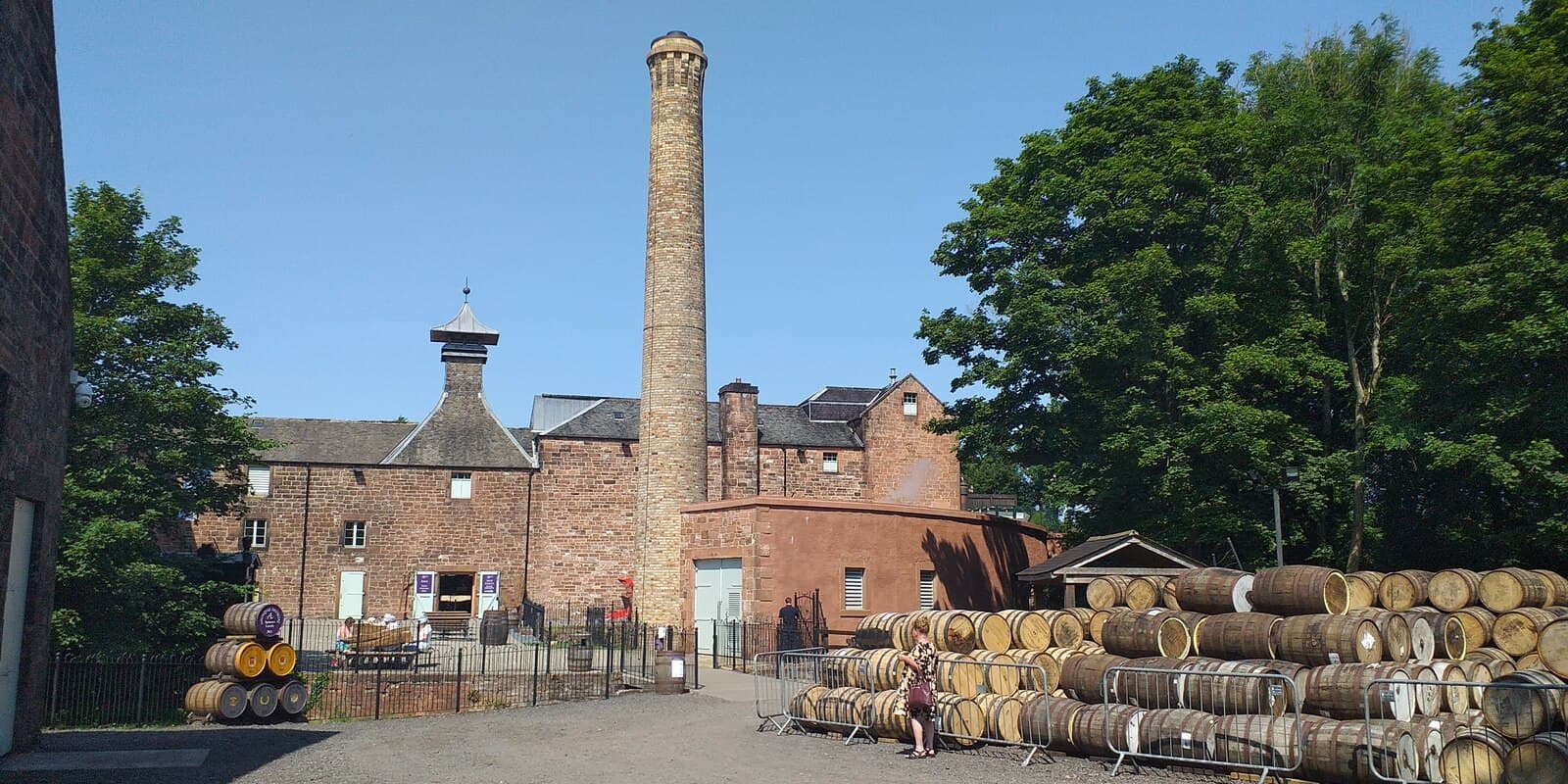 Annandale distillery's brick chimney and stacked casks near Annan
