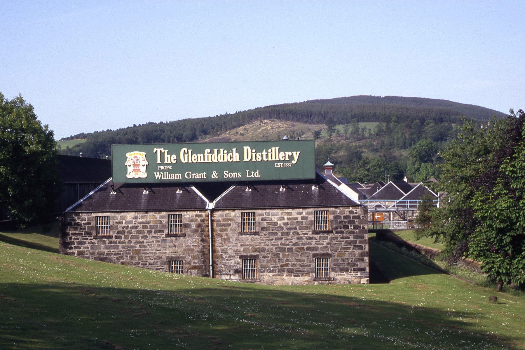 The Glenfiddich Distillery signboard on the old stone maltings at Dufftown