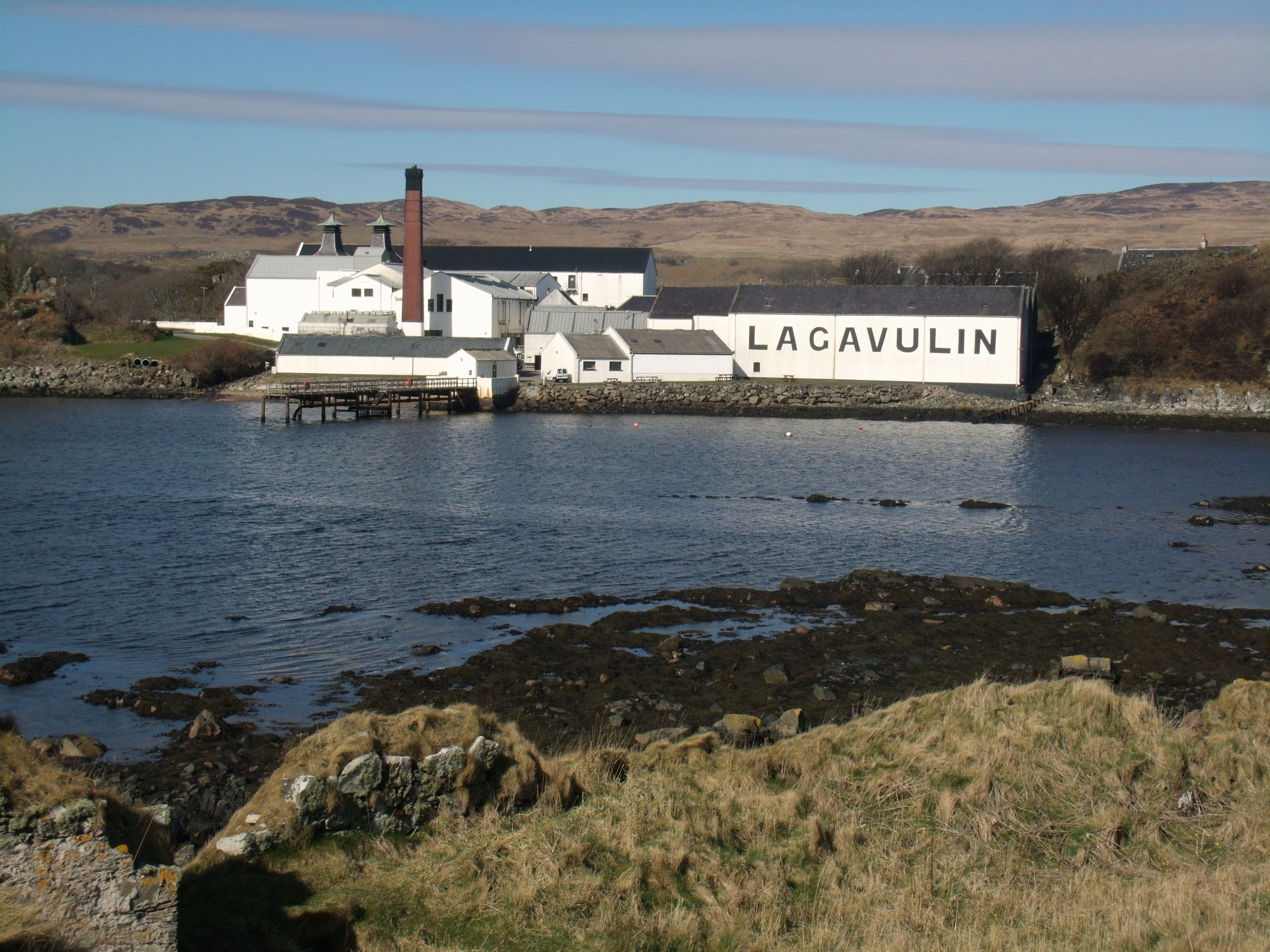 Lagavulin distillery's white-washed buildings on the shore of Lagavulin Bay, Islay