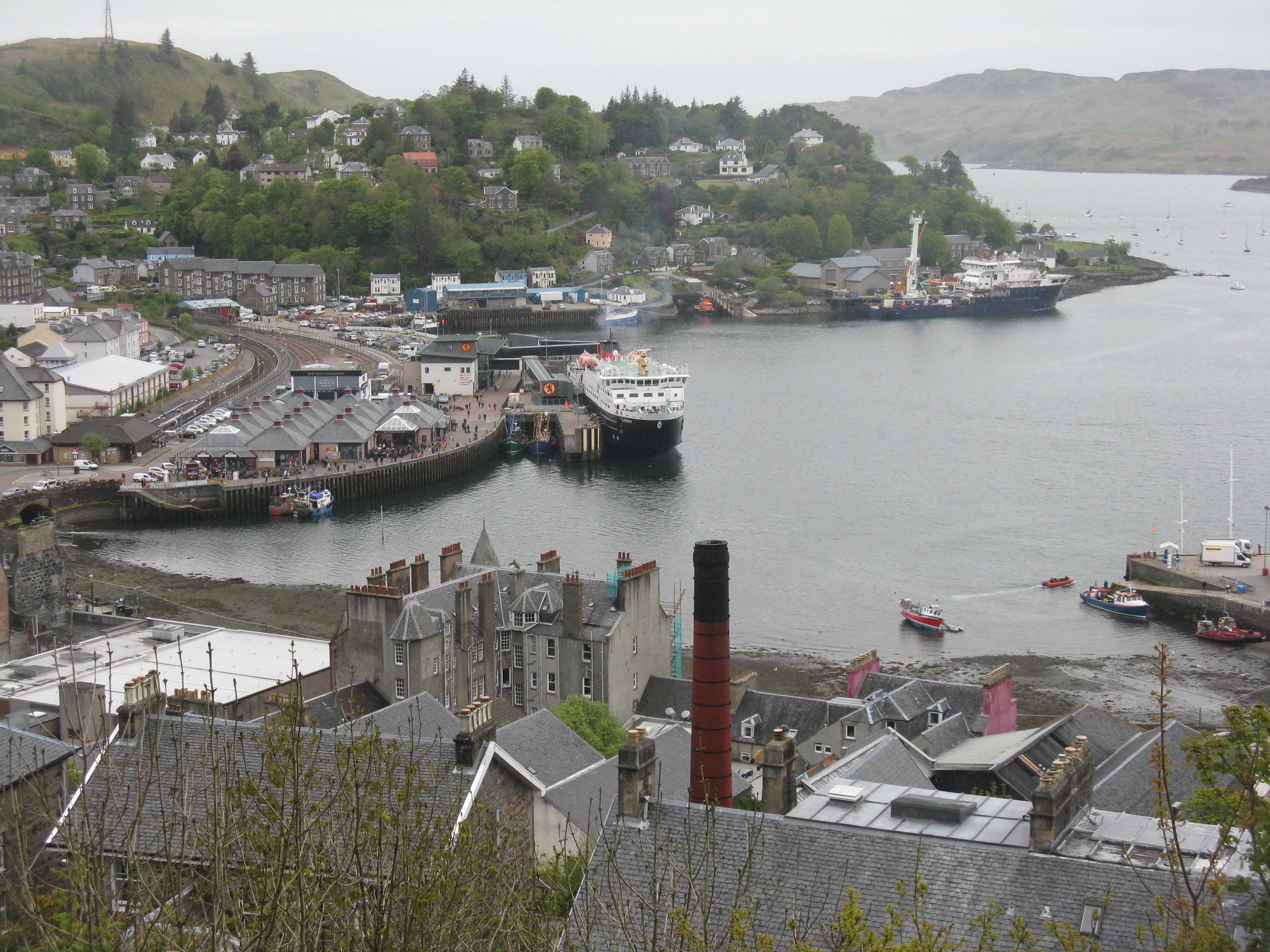 Oban harbour, the railway pier and a CalMac ferry seen from McCaig's Tower