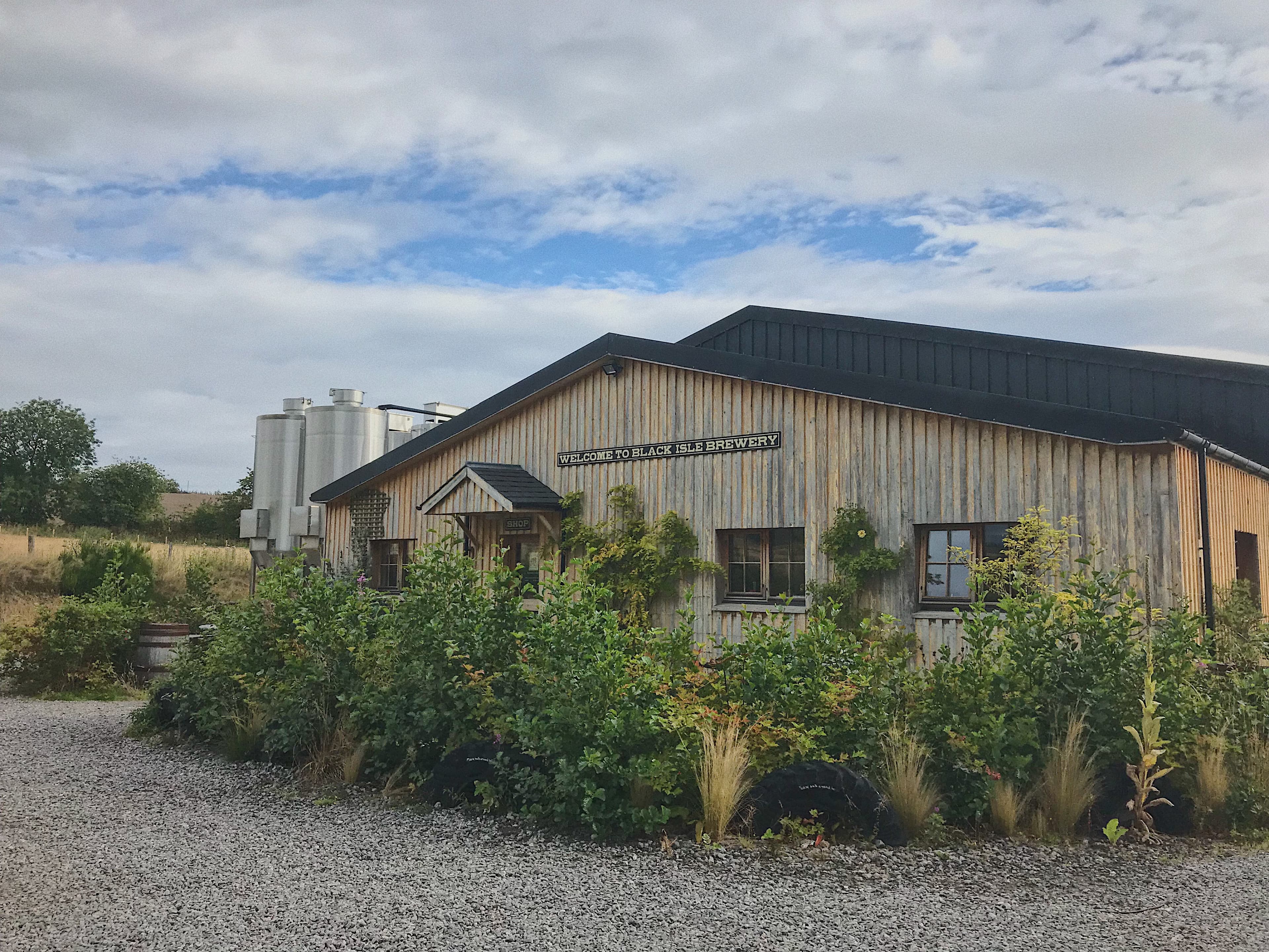 The timber-clad Black Isle Brewery building near Munlochy, fermenting tanks behind