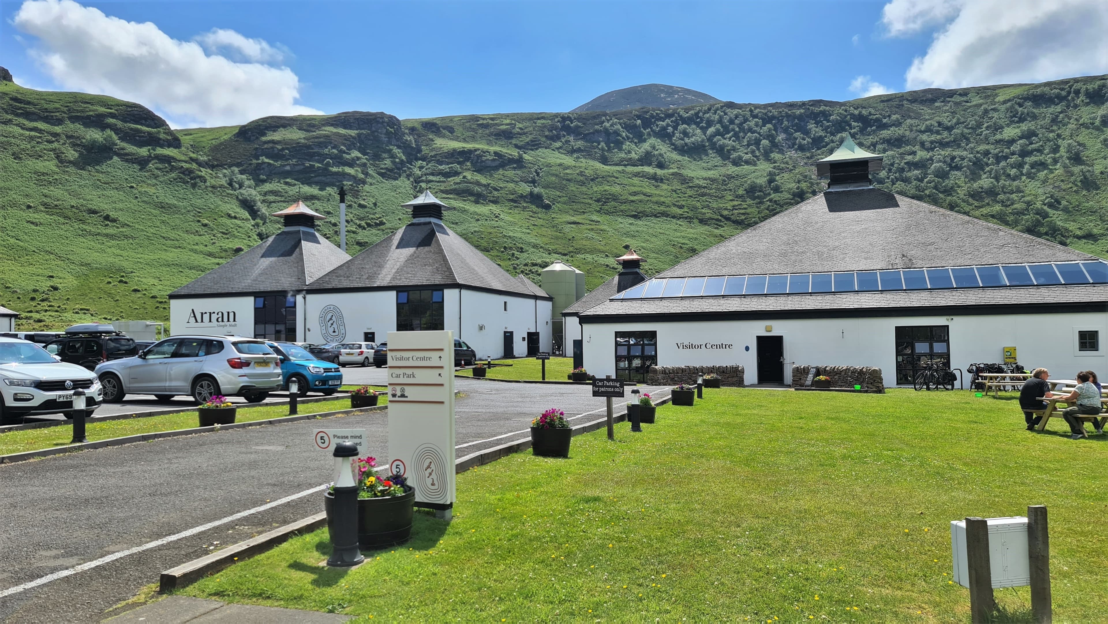 The Arran distillery visitor centre at Lochranza beneath the hills