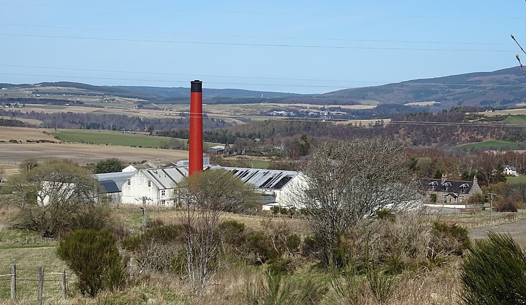Benrinnes distillery and its red chimney below the hill