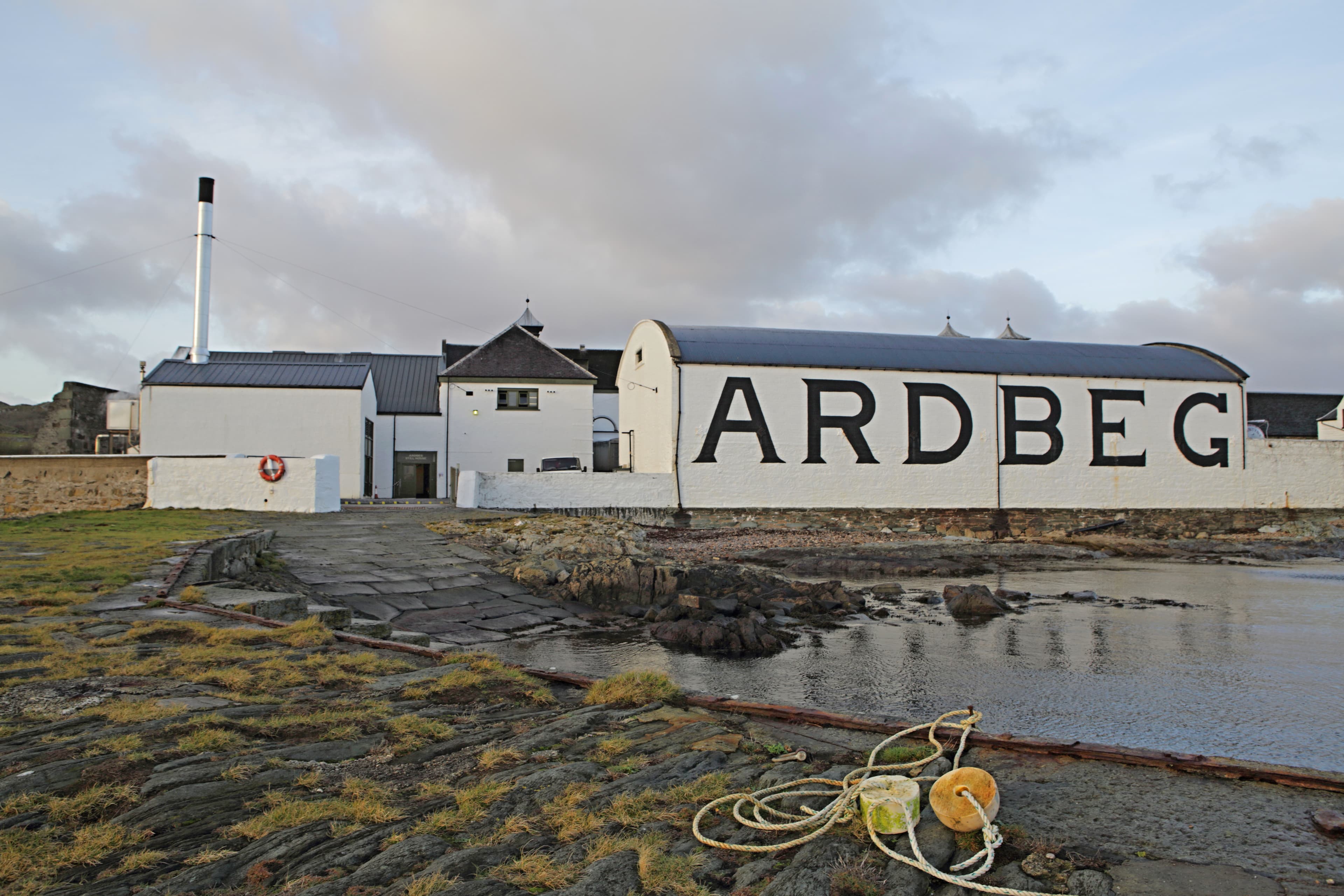 Ardbeg distillery's shoreline warehouse with the name in black lettering