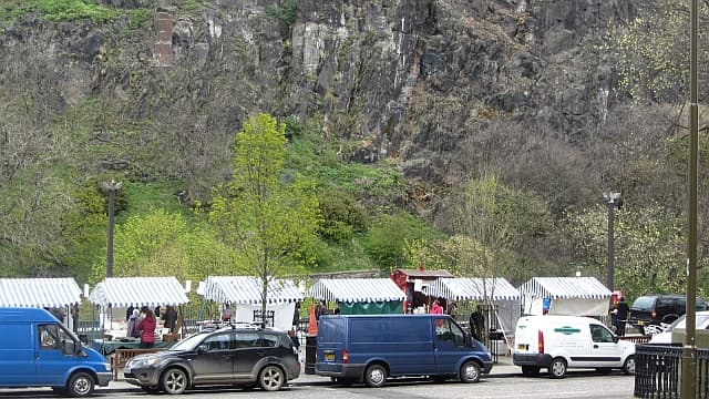 Striped stalls of the Edinburgh Farmers’ Market on Castle Terrace, under the Castle rock