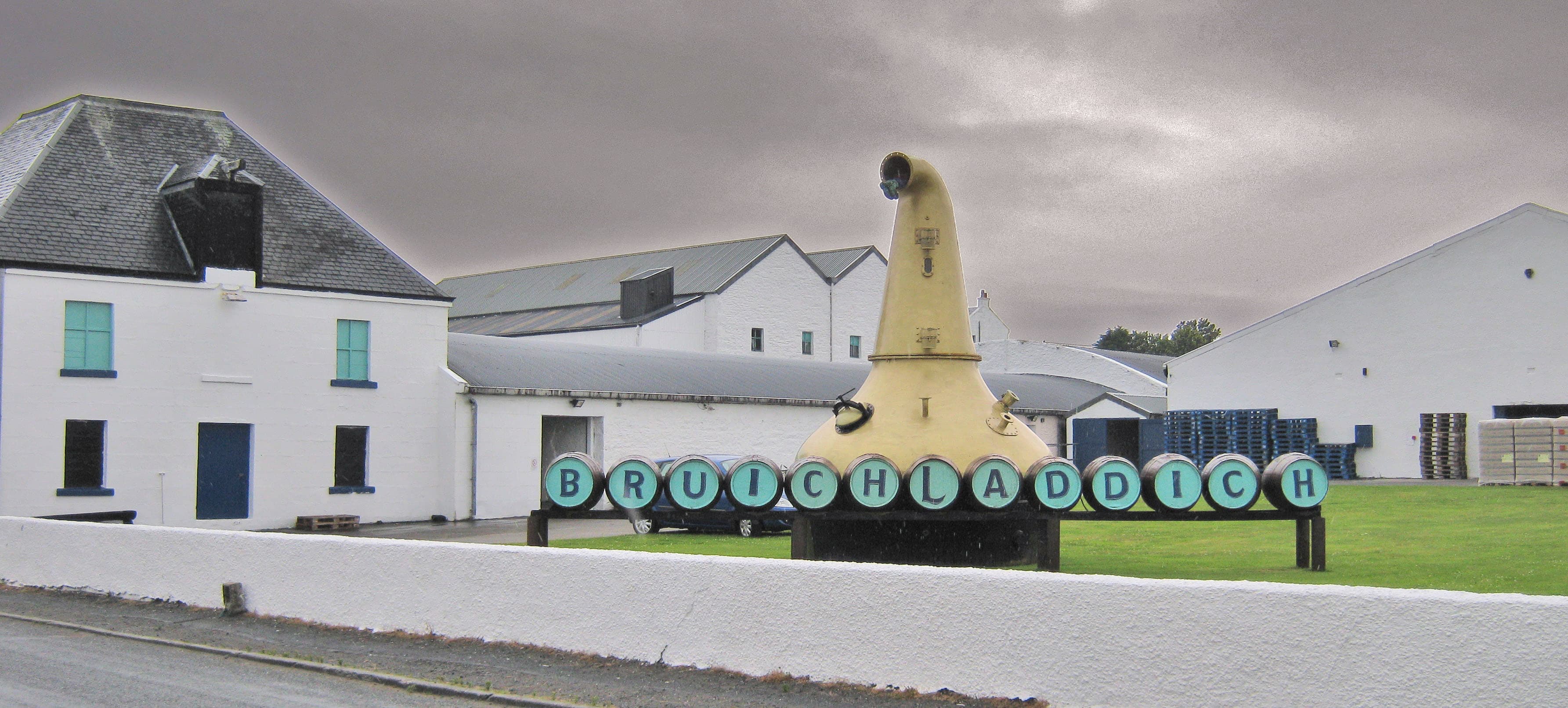 Bruichladdich distillery's whitewashed buildings on the shore of Loch Indaal
