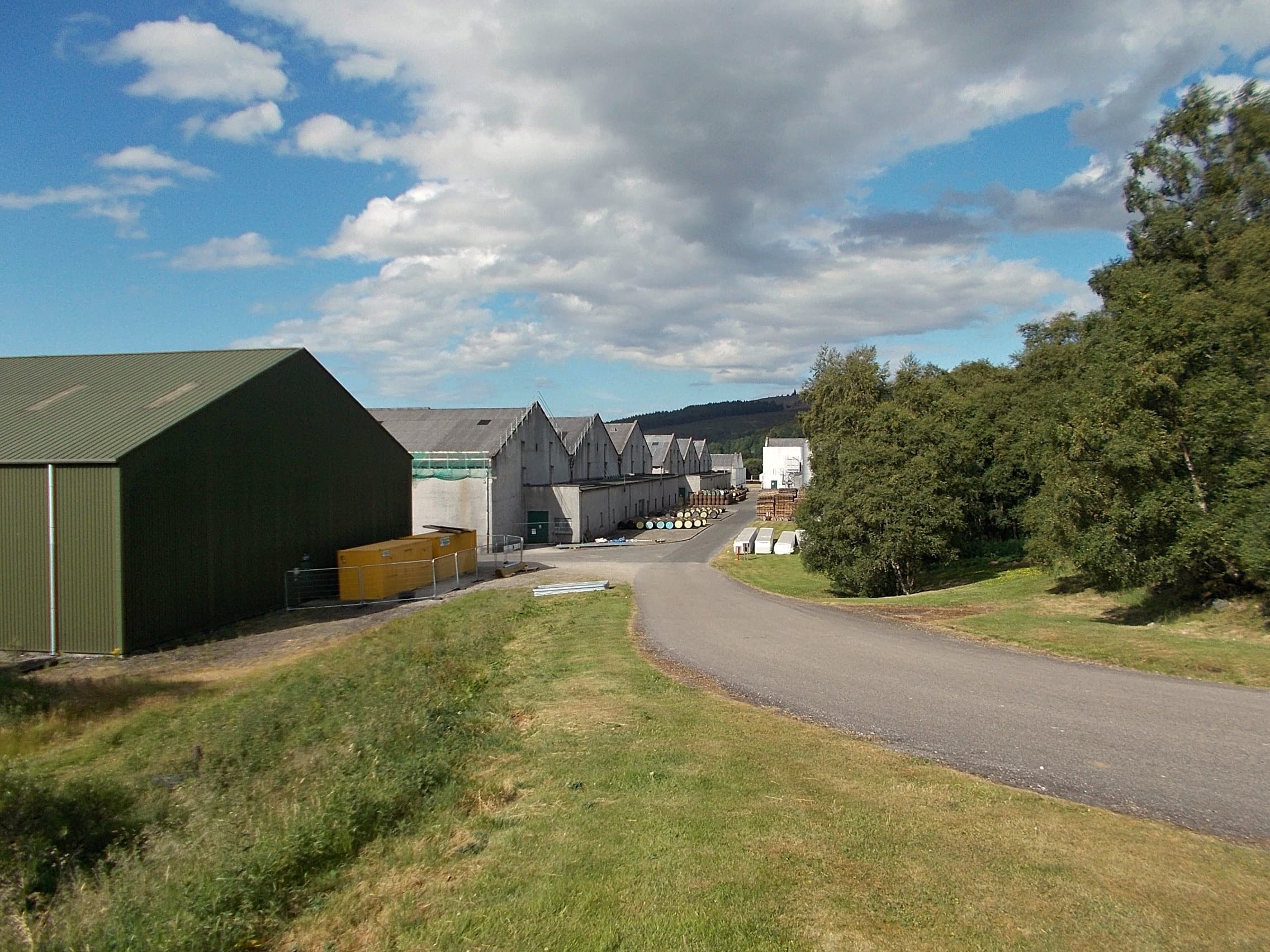 The green-clad warehouses lining the approach to Tomintoul distillery