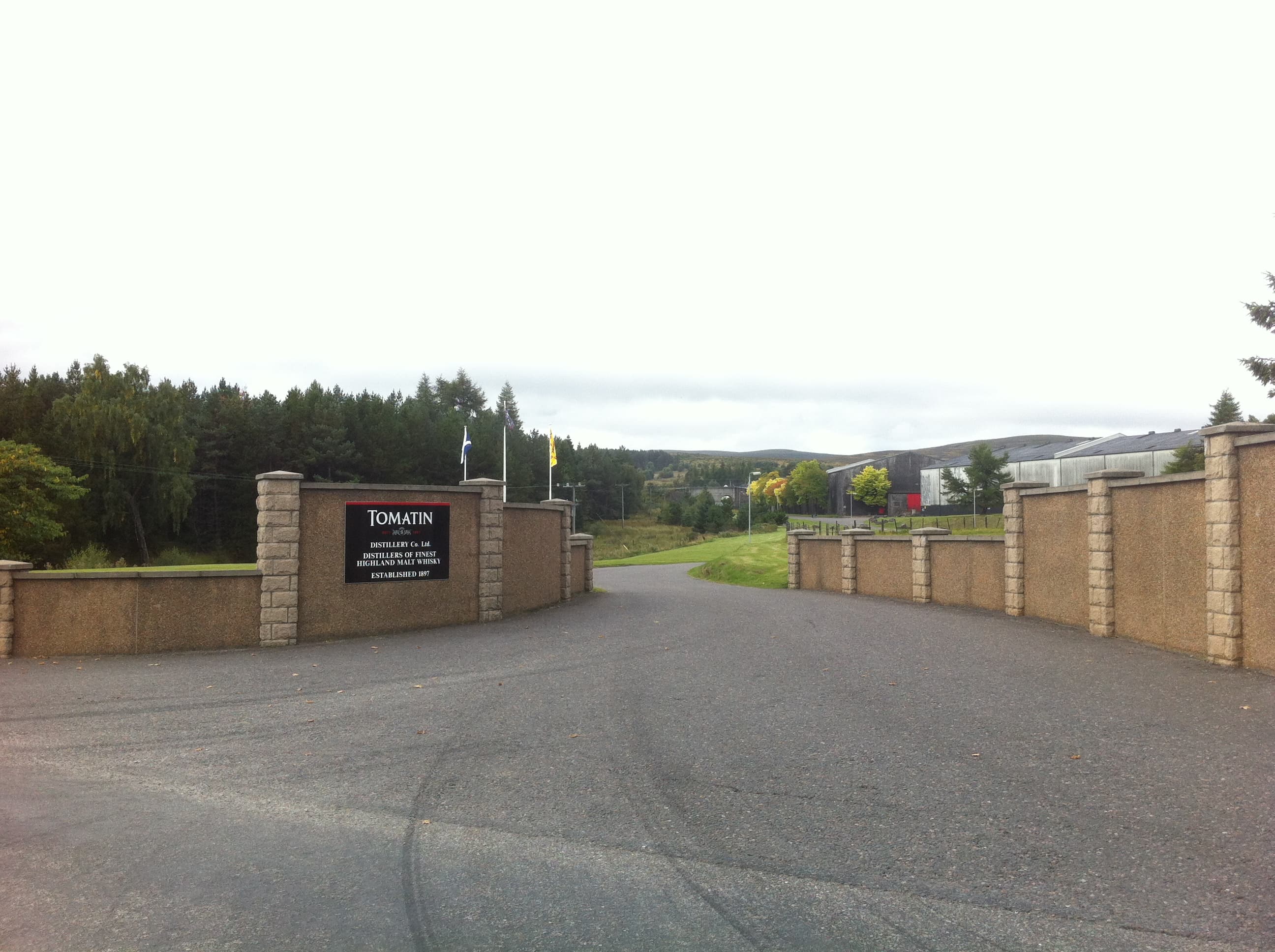 The stone entrance wall and nameplate at Tomatin distillery